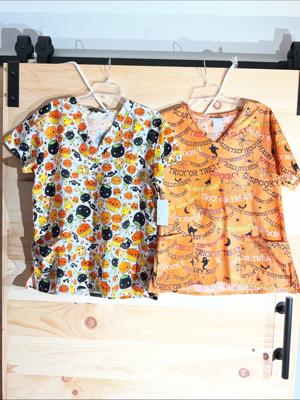 Set of 2 Halloween scrub tops, one L NWT, one M.